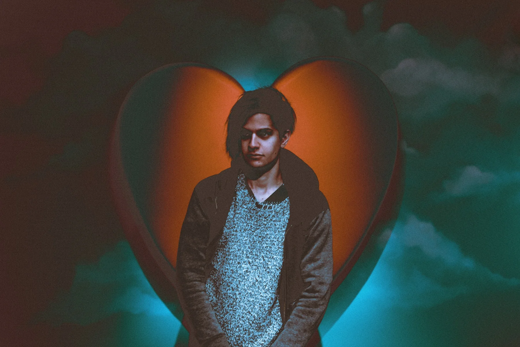 Omri portrait in front of an illuminated heart set